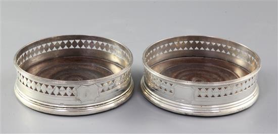 A pair of George III pierced silver wine coasters, diameter 11.8cm.